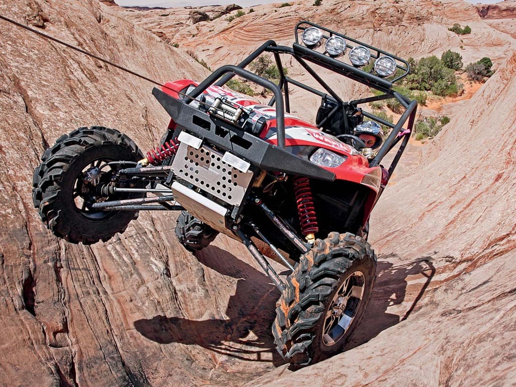 2010.kawasaki.teryx_.red_.front_.using-winch.over-rocks.jpg